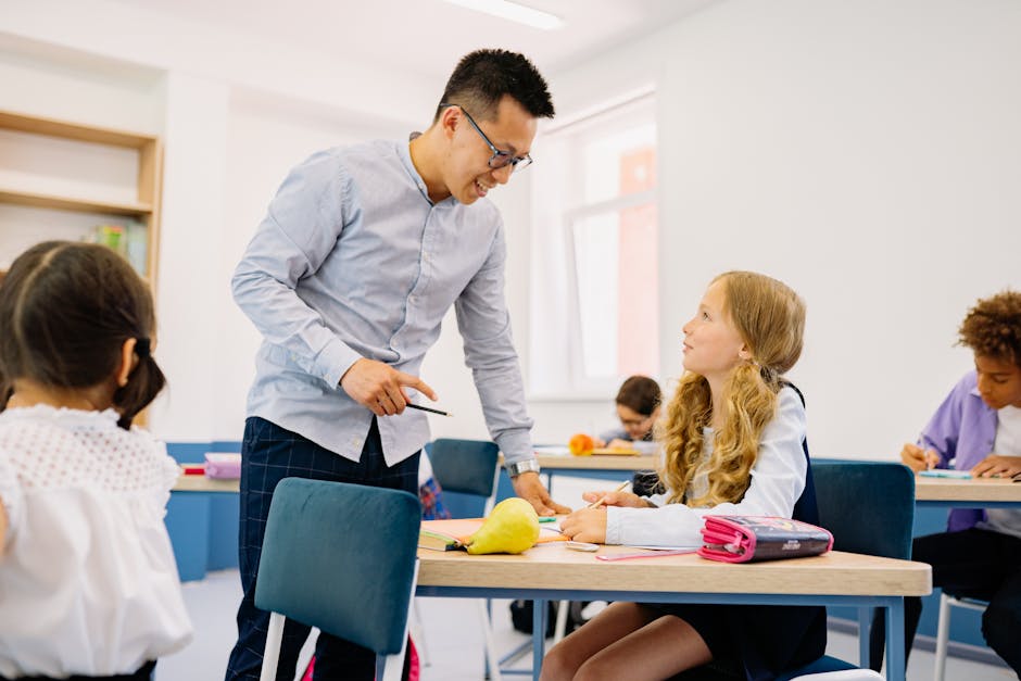 A male teacher interacting with diverse students in a bright classroom setting, promoting active learning